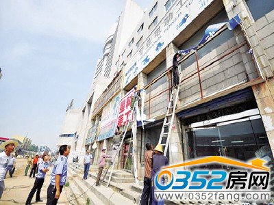 工作人員正在拆除廣告牌